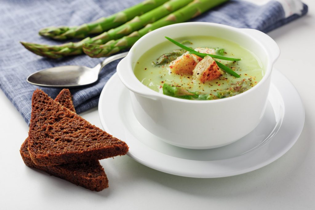Asparagus soup in white bowl